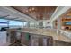 Outdoor summer kitchen with granite countertops, stainless steel appliances, and water views at 7706 Desoto Memorial Hwy, Bradenton, FL 34209