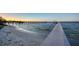 Beautiful scene of a dock and beach on the water at sunset at 7706 Desoto Memorial Hwy, Bradenton, FL 34209