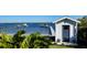 Waterfront property featuring lush landscaping with a private dock at 7706 Desoto Memorial Hwy, Bradenton, FL 34209