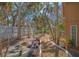 Secluded backyard with a white fence, winding pathway, and mature trees at 813 Plymouth St, Sarasota, FL 34242