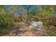 Cozy backyard bench nestled amongst the trees and foliage, ideal for relaxing at 813 Plymouth St, Sarasota, FL 34242