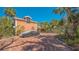 Stunning two-story home featuring brick driveway, lush landscaping, and a covered vehicle at 813 Plymouth St, Sarasota, FL 34242