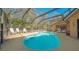 Sparkling screened-in pool with ample seating, surrounded by lush tropical foliage at 813 Plymouth St, Sarasota, FL 34242