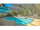 Backyard pool oasis with screened enclosure, complemented by surrounding lush greenery at 813 Plymouth St, Sarasota, FL 34242