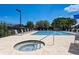 Resort-style pool area featuring a jacuzzi and plenty of lounge chairs for relaxation at 8735 Olde Hickory Ave # 8303, Sarasota, FL 34238