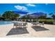 Relaxing pool area with blue umbrellas, tables, and chairs for lounging at 8735 Olde Hickory Ave # 8303, Sarasota, FL 34238