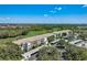 Aerial view of condo building with a golf course view and carports at 8735 Olde Hickory Ave # 8303, Sarasota, FL 34238