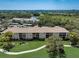 Aerial view of condo buildings with manicured lawn and sidewalk at 8735 Olde Hickory Ave # 8303, Sarasota, FL 34238