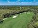 Stunning aerial view of a lush golf course with mature trees at 8735 Olde Hickory Ave # 8303, Sarasota, FL 34238