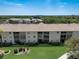 Aerial view of condo buildings with manicured lawn and sidewalk at 8735 Olde Hickory Ave # 8303, Sarasota, FL 34238