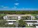 Aerial view of condo building with carports and golf course views at 8735 Olde Hickory Ave # 8303, Sarasota, FL 34238