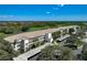 Aerial view of condo building with a golf course view and carports at 8735 Olde Hickory Ave # 8303, Sarasota, FL 34238