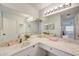 Bathroom featuring an oversized mirror, double sinks, and marble countertops at 8735 Olde Hickory Ave # 8303, Sarasota, FL 34238