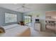 Bright bedroom with ceiling fan, sliders to lanai, and ensuite bathroom at 8735 Olde Hickory Ave # 8303, Sarasota, FL 34238