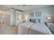 Bright bedroom with two twin beds, ceiling fan, and mirrored closet at 8735 Olde Hickory Ave # 8303, Sarasota, FL 34238