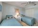 Cozy bedroom with two beds, ceiling fan, and closet at 8735 Olde Hickory Ave # 8303, Sarasota, FL 34238