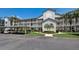 Exterior shot of a multi-story condo building with balconies, carports, and palm trees at 8735 Olde Hickory Ave # 8303, Sarasota, FL 34238