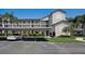 Exterior shot of a multi-story condo building with balconies, carports, and palm trees at 8735 Olde Hickory Ave # 8303, Sarasota, FL 34238