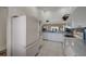 Large kitchen with white appliances, ample cabinet space, and tile flooring at 8735 Olde Hickory Ave # 8303, Sarasota, FL 34238