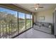 Enclosed lanai featuring tile flooring, ceiling fan, and beautiful golf course views at 8735 Olde Hickory Ave # 8303, Sarasota, FL 34238