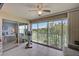 Enclosed lanai with an exercise bike, golf course views, and sliding glass doors at 8735 Olde Hickory Ave # 8303, Sarasota, FL 34238