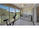 Enclosed lanai features tile floor and large windows with golf course views, creating a bright and airy space at 8735 Olde Hickory Ave # 8303, Sarasota, FL 34238