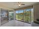 Enclosed lanai features tile floor and large windows with golf course views, creating a bright and airy space at 8735 Olde Hickory Ave # 8303, Sarasota, FL 34238