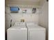 Functional laundry room with a washer, dryer, and overhead shelving at 8735 Olde Hickory Ave # 8303, Sarasota, FL 34238