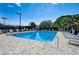 Community pool with many lounge chairs and beautiful, well-maintained landscaping at 8735 Olde Hickory Ave # 8303, Sarasota, FL 34238