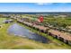 Scenic aerial view of the condo community, showcasing the lake, golf course and central location at 923 Fairwaycove Ln # 103, Bradenton, FL 34212
