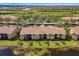 Expansive aerial view of community featuring pristine lake and manicured lawns at 923 Fairwaycove Ln # 103, Bradenton, FL 34212