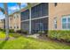 Scenic view of backyard and screened-in porch overlooking manicured lawn and vibrant greenery at 923 Fairwaycove Ln # 103, Bradenton, FL 34212