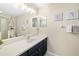 Bathroom showcasing a blue vanity, decorative mirrors and sconce lighting at 923 Fairwaycove Ln # 103, Bradenton, FL 34212