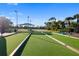 Community bocce ball court featuring artificial grass and nearby lake view at 923 Fairwaycove Ln # 103, Bradenton, FL 34212