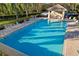 Community pool with inviting lounge chairs and a shaded pavilion with seating area at 923 Fairwaycove Ln # 103, Bradenton, FL 34212