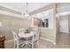 Cozy dining area featuring a white table with seating for four, and a view into the kitchen at 923 Fairwaycove Ln # 103, Bradenton, FL 34212