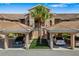 Inviting condo with covered parking, lush landscaping, and tile roof, offering comfort and convenience at 923 Fairwaycove Ln # 103, Bradenton, FL 34212