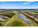 Exterior view of a multi-unit building with a lake and grassy lawn at 923 Fairwaycove Ln # 103, Bradenton, FL 34212