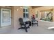 Inviting front porch featuring Adirondack chairs, a small table and view of the main entrance door at 923 Fairwaycove Ln # 103, Bradenton, FL 34212