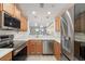 Modern kitchen with stainless steel appliances, quartz countertops, and a seamless flow into the living area at 923 Fairwaycove Ln # 103, Bradenton, FL 34212