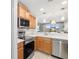 Modern kitchen with stainless steel appliances, light countertops, and open concept design at 923 Fairwaycove Ln # 103, Bradenton, FL 34212