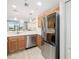 Kitchen with stainless steel appliances, tile floors, and a view into the living room at 923 Fairwaycove Ln # 103, Bradenton, FL 34212