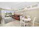 A spacious living room and dining area with views of the screened lanai and pond beyond at 923 Fairwaycove Ln # 103, Bradenton, FL 34212