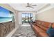Bright living room featuring a plush leather sofa, stylish zebra rug and sliding door to the lanai at 923 Fairwaycove Ln # 103, Bradenton, FL 34212