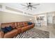 Spacious living room flows into the dining area, featuring a comfortable couch and stylish zebra rug at 923 Fairwaycove Ln # 103, Bradenton, FL 34212