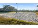 Community sand volleyball court with lake backdrop and net at 923 Fairwaycove Ln # 103, Bradenton, FL 34212