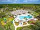 An aerial view showcases a community pool, clubhouse, and surrounding lush landscape at 1102 Jonah Dr # 1102, North Port, FL 34289