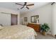 Bright bedroom with ceiling fan, stylish decor, and smooth sliding door at 11120 Marigold Dr, Lakewood Ranch, FL 34202