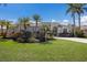 Welcoming home featuring lush landscaping, palm trees, and a curved driveway at 11120 Marigold Dr, Lakewood Ranch, FL 34202