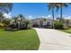 Stunning home boasts a beautifully landscaped front yard and swaying palm trees at 11120 Marigold Dr, Lakewood Ranch, FL 34202